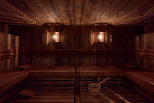 a large wooden room with a bucket in it at Miiro The Mansard in Gstaad