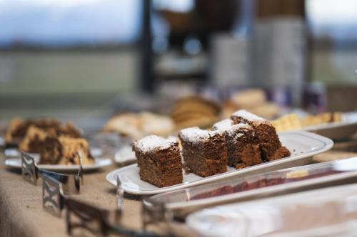 a plate of cake and other pastries on a table at Hotel Hacienda Dorotea in Puerto Natales
