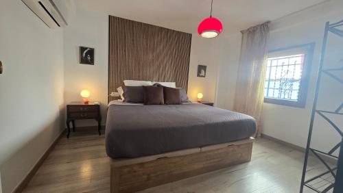 a bedroom with a large bed and a window at Casa el "Tablao de las Almendras" in Granada