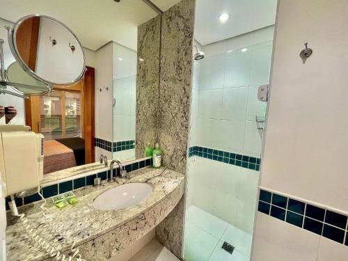 a bathroom with a sink and a mirror at LFlats no Hotel Stella Vega (EX-Mercury Ibirapuera) in Sao Paulo