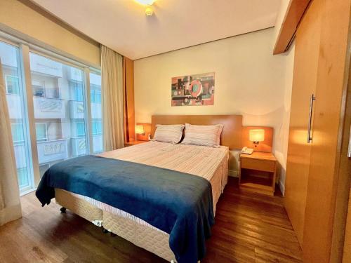 a bedroom with a large bed and a large window at LFlats no Hotel Stella Vega (EX-Mercury Ibirapuera) in Sao Paulo