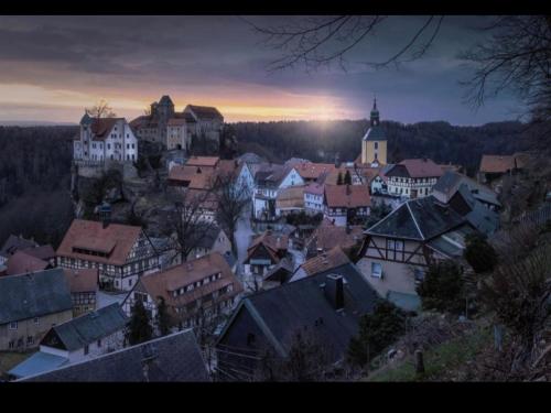 a group of buildings in a town at sunset at Ferienwohnung "EDDI" in Hohnstein