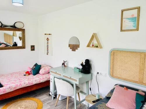 a bedroom with a desk and a bed and a desk at CasaZaPatos Bungalows in Nigrán