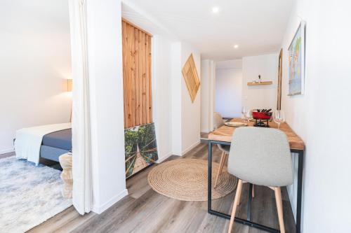 a small room with a desk and a bed at Cute & cozy oasis, private afternoon sun terrace in Kandersteg