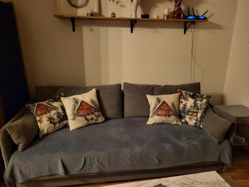 a couch with pillows on it in a living room at Sahlin - Kattarp in Kattarp