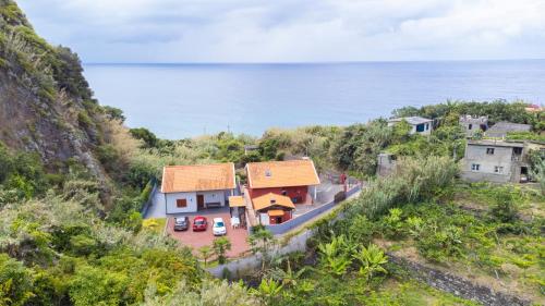an aerial view of a house with the ocean in the background at Casa del Mar II by GALMI in Arco de São Jorge
