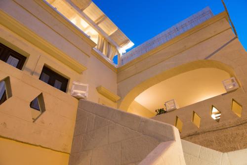 an external view of a building with an arch at Antica Via Roma B&B E RELAX in Montalbano