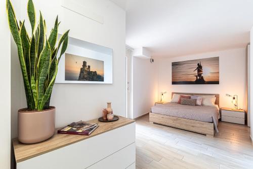 a bedroom with a bed and a potted plant at Independent House a due passi dal Centro Storico in San Marino