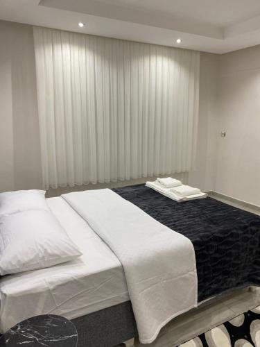 a bedroom with two beds with white sheets at Aras Home in Pamukkale
