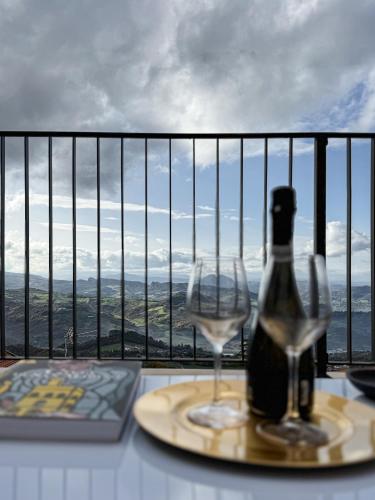 a bottle of wine and a glass on a table at Independent House a due passi dal Centro Storico in San Marino