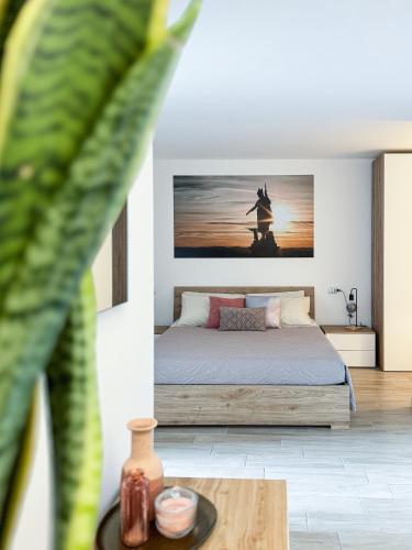 a bedroom with a bed with a painting on the wall at Independent House a due passi dal Centro Storico in San Marino