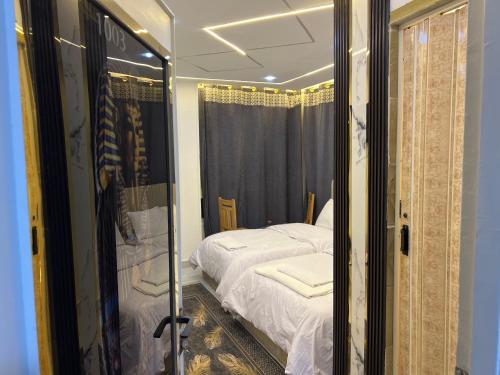a reflection of a bedroom with a bed in a mirror at Miracle Pyramids View Hotel in Giza