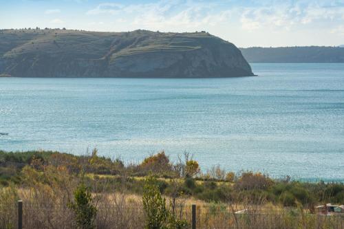 a large body of water with a mountain in the background at MY DALMATIA - Sea view holiday home Fortica in Rtina