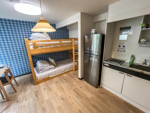 a small kitchen with bunk beds and a refrigerator at Hostel In Kyoto Gion - Vacation STAY 13366v in Gionmachi