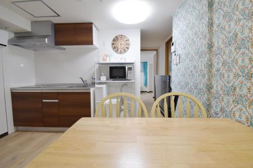 a kitchen and dining room with a table and chairs at Hostel In Kyoto Gion - Vacation STAY 13917v in Gionmachi