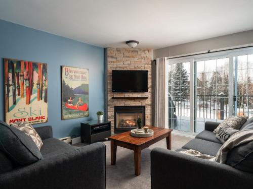 a living room with two couches and a fireplace at Ski In Out view on Mont-Blanc hills - Le Loup in Mont-Blanc