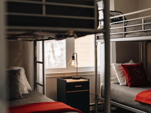 a bedroom with two bunk beds and a lamp at Ski In Out view on Mont-Blanc hills - Le Loup in Mont-Blanc