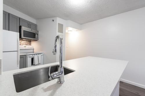 a kitchen with a sink and a faucet at Downtown Honolulu Skyview - 1Bed&Den- Free Parking in Honolulu