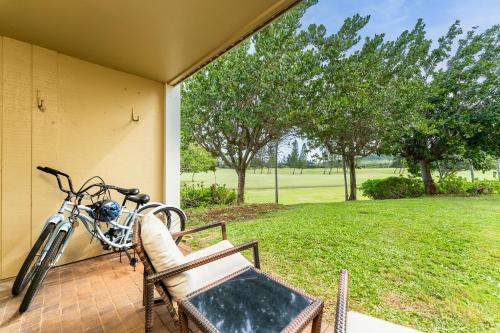 a bike is parked on a porch with a chair at Welcome to Gorgeous Hideout – Your Serene Hawaiian Escape! in Kahuku