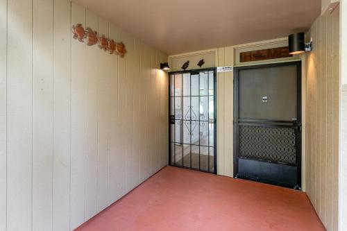 an empty room with a door to a cell with a gate at Welcome to Gorgeous Hideout – Your Serene Hawaiian Escape! in Kahuku