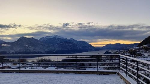 a view of a snowy mountain with a lake and mountains at Casa Luca in Plesio