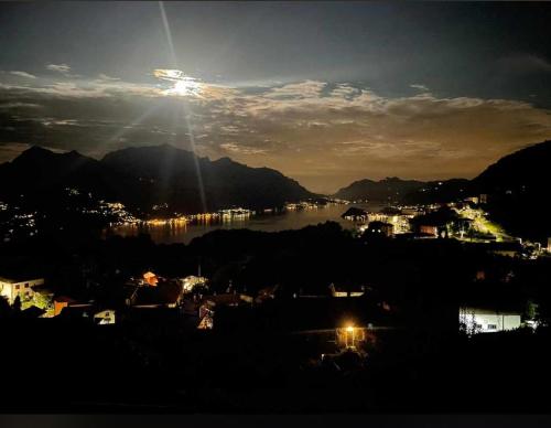 a view of a city and a lake at night at Casa Luca in Plesio