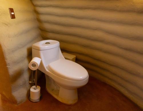 a bathroom with a white toilet in a room at CACTACEO - alojamiento desértico in Chapala