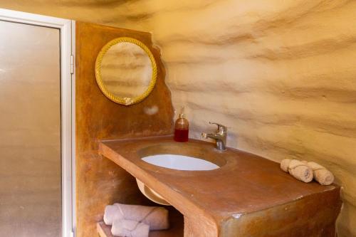 a bathroom with a wooden sink and a mirror at CACTACEO - alojamiento desértico in Chapala