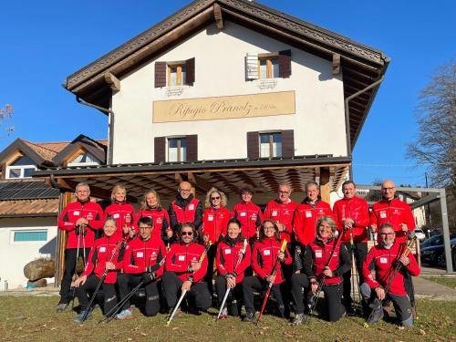 a group of people posing for a picture in front of a building at Rifugio Pranolz in Trichiana