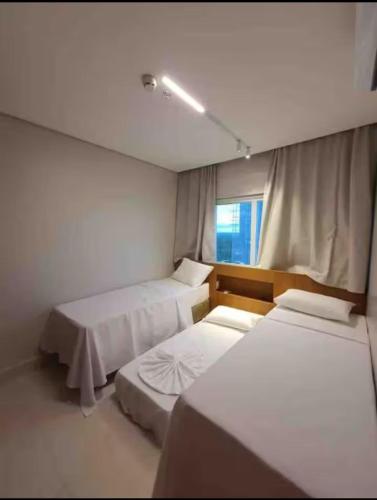 a room with two beds and a window at Salinas Exclusive Resort in Salinópolis