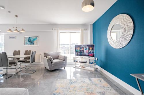 a living room with a blue accent wall at Radharc na mBáid in Galway