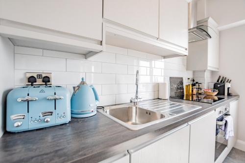 a kitchen with a sink and a blue appliance at Radharc na mBáid in Galway