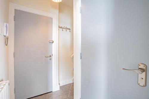 a white door in a room with a bathroom at Radharc na mBáid in Galway