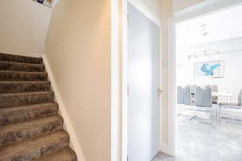 a staircase in a home with white walls at Radharc na mBáid in Galway