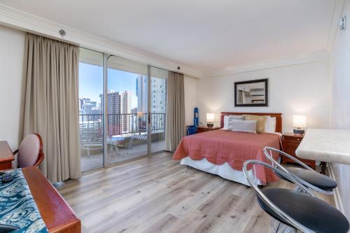 a hotel room with a bed and a balcony at Royal Garden Waikiki - Ocean View - Resort Amenities in Honolulu