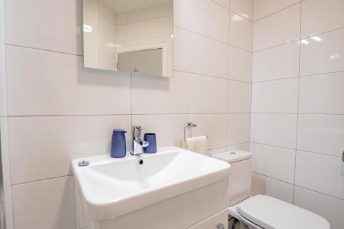 a white bathroom with a sink and a toilet at Radharc na mBáid in Galway