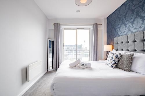 a bedroom with a large bed with a large window at Radharc na mBáid in Galway