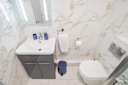 a white bathroom with a sink and a toilet at Radharc na mBáid in Galway