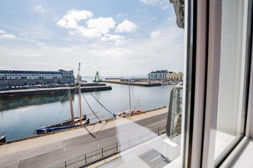 a view from a window of a river with a boat at Radharc na mBáid in Galway