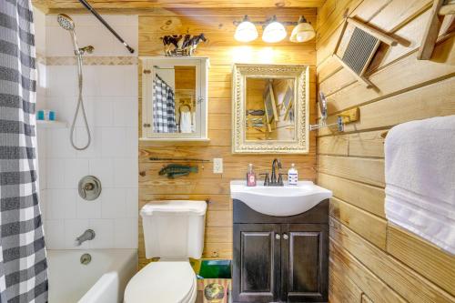 a bathroom with a toilet and a sink at Steps to Lake Okeechobee Cabin with Pool Access! in Okeechobee