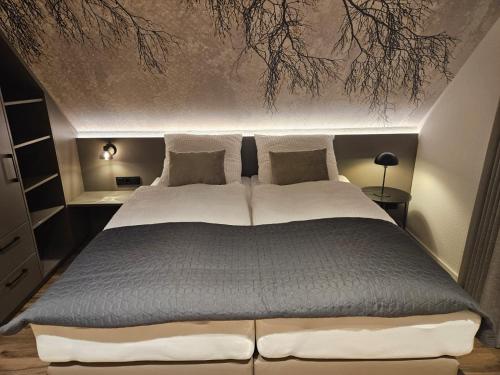 a bedroom with a large bed in a room at Geling Pension Apartments Stadtlohn in Stadtlohn
