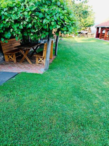 a picnic table in a field of green grass at Kablar Lazino Brdo in Čačak