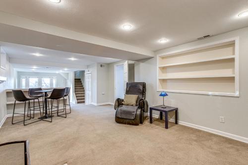 a living room with a table and chairs at Spacious Home with Fenced Yard 6 Mi to Dtwn Denver! in Englewood