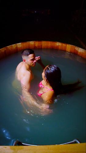 a man and a woman in a pool of water at Viscas Lodge in Carhuaz