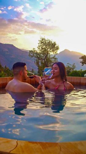 a man and a woman in a swimming pool at Viscas Lodge in Carhuaz