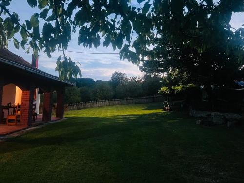 a yard with a fence and a grassy field at Kablar Lazino Brdo in Čačak
