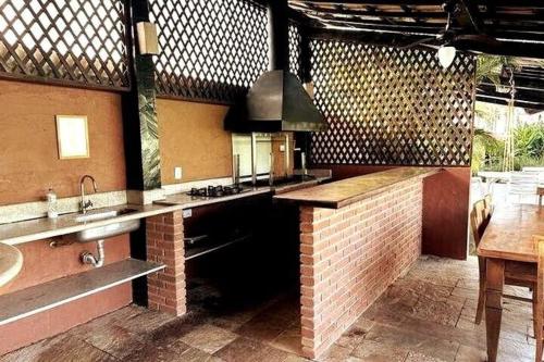 a kitchen with a brick counter and a sink at Praia da Baleia | Frente ao Mar c/ Quiosque in São Sebastião