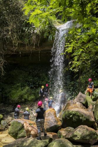 a group of people standing in front of a waterfall at Ixora travel in Acacías
