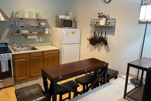 a kitchen with a table and a white refrigerator at SlopeSide Escape in Newry