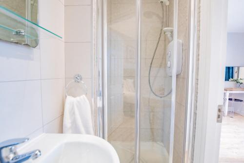 a bathroom with a shower and a sink at Harbour View in Galway